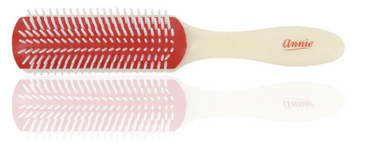 Red and white hairbrush with 'Annie' branding on a white background